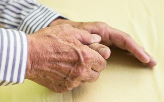 elderly-man-s-hand-one-hand-holding-the-thumb-of-the-other-due-to-arthritis-pain